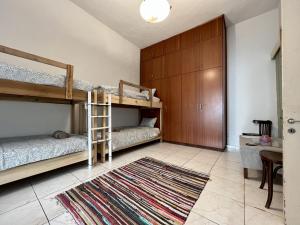 two bunk beds in a room with a rug at Retro Hostel in Limassol