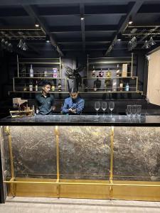 two men sitting at a bar in a restaurant at The Shanti A Boutique Hotel in Jodhpur