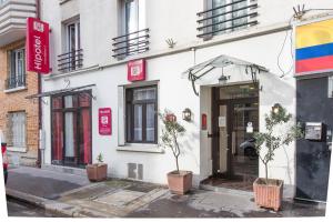 a white building with plants in front of it at Hipotel Paris Père-Lachaise République in Paris
