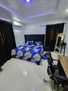 a bedroom with a bed and a table and a chair at Serene Oasis in Ikorodu