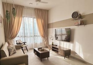 a living room with a couch and a table at Tranquil Suite, MKH Boulevard 2 in Kajang