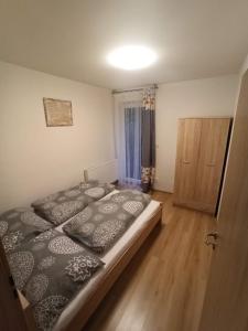 a bedroom with a large bed and a wooden floor at Penzion U Tomanů in Jaroměřice na Rokytné