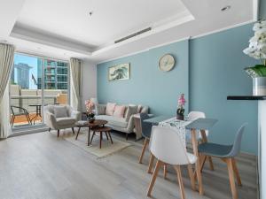 a living room with blue walls at Lush Interior Brand New 1BDR-Heart of Downtown in Dubai