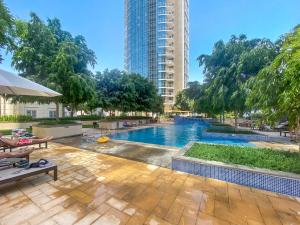 a swimming pool with a tall building in the background at Lush Interior Brand New 1BDR-Heart of Downtown in Dubai