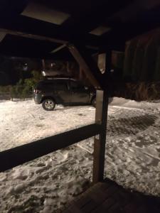 a black truck parked in the snow at Alfa 2 apartament 3 in Bystra
