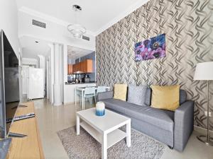 a living room with a couch and a table at Brand New 1BDR Dubai Marina -Close to Metro in Dubai