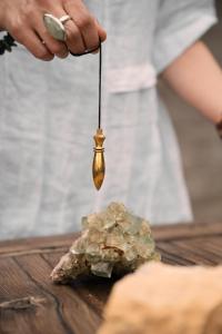 a person holding a gold spoon over a rock at BIOHOTEL StDaniel in Štanjel