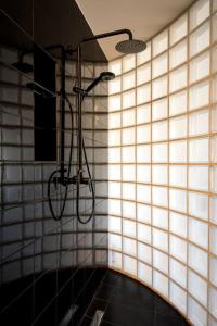 a bathroom with a shower in a tiled wall at Hoppersgr- Amazing apt in the heart of Athens - 4 in Athens