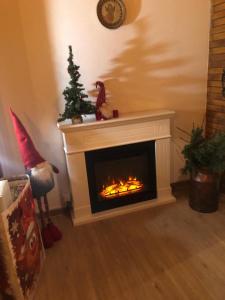 a living room with a fireplace with a christmas tree at Ferienhaus Astenblick für große Gruppen - Familienfeiern oder Betriebsfeiern in Winterberg