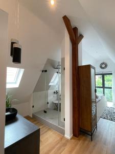 a bathroom with a glass shower in a attic at Stadtvilla Apartments Ferienwohnungen Weinsberg in Weinsberg