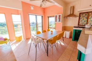 a kitchen with a table and chairs in a room at Tropical Soul Okinawa in Teruya