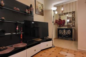 a living room with a large flat screen tv at Mery's Countryside House in Agios Mamas +40 photos