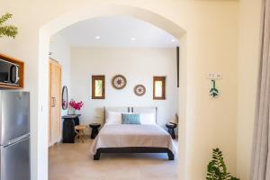 a bedroom with a bed and a refrigerator at MerTelia Luxury Villas in Kyra Panagia