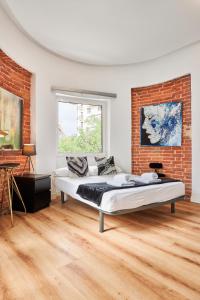 a bedroom with a bed and a brick wall at Hermosilla Prime, by Presidence Rentals in Madrid