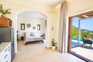 a bedroom with a bed and a view of the ocean at MerTelia Luxury Villas in Kyra Panagia +163 photos