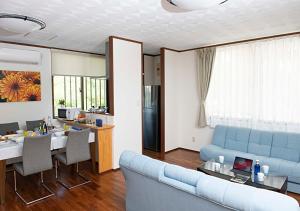 a living room with a blue couch and a table at Miyakojima White House Annex in Miyako-jima +42 photos