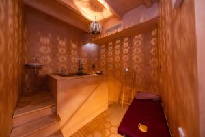 a bathroom with a sink and a wooden wall at Yartan Boutique Hotel - Adults Only in Artá