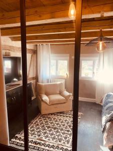 a living room with a couch and a tv at LA MARIEFACTURE - Comm chez Mémé in Laning