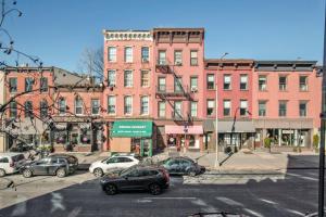 a city street with cars parked in front of buildings at Cobble Hill 1BR w in-unit WD nr Trader Joes NYC-728 in Brooklyn