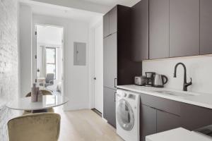 a kitchen with a sink and a washing machine at Cobble Hill 1BR w in-unit WD nr Trader Joes NYC-728 in Brooklyn