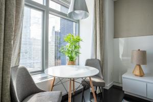 a table and chairs in a room with a window at Tribeca studio w elevator nr world trade center NYC-1357 in New York