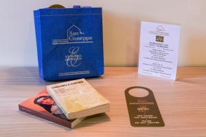 a table with a book and a box and a bookmark at Casa San Giuseppe in Rome