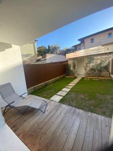 a chair sitting on a deck in a backyard at Exclusive house in Marostica in Marostica