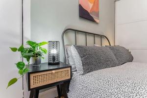 a bedroom with a bed and a table with a plant at Traditional 1-Bed Flat in Southside (Hampden/Shawlands) in Glasgow