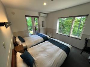 Postel nebo postele na pokoji v ubytování Chalet Fuyuri