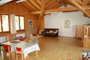 a living room with a table and chairs at Ferienwohnungen JHS in Seewis im Prättigau