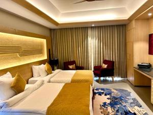 a hotel room with two beds in a room at Ananta Spa & Resort Jaipur in Jaipur
