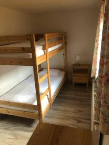 a couple of bunk beds in a room at Vidiecky domček in Pohronská Polhora