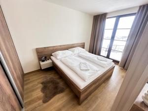 Postel nebo postele na pokoji v ubytování Apartmány nad Anenským potokem - Říčky