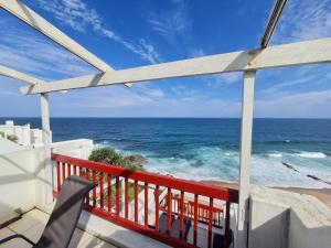 a view of the ocean from the balcony of a house at Santorini Beach Views - 23 Perissa in Ballito