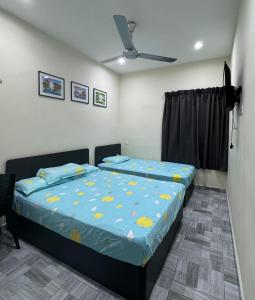 a bedroom with a bed and a ceiling fan at 西子楼 CZI Budget Hotel Sungai Siput in Sungai Siput