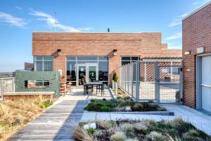 a brick house with a patio with a table at Bethesda 2br w wd gym pool nr dining WDC-660 in Bethesda