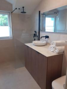 a bathroom with a sink and a mirror at Werz Sea View Apartment in Brela