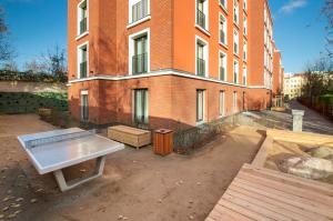 a bench in front of a brick building at NEOApartments in Berlin