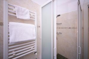 a bathroom with a towel rack and a shower at Casa San Giuseppe in Rome