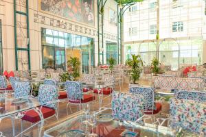 a room with tables and chairs in a building at Millennium Place Doha in Doha