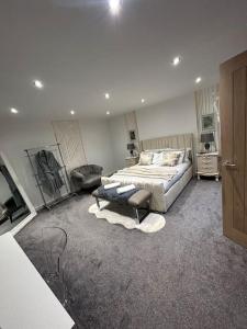 a large bedroom with a bed and a couch at Secret Cabin Getaway in Hartlepool