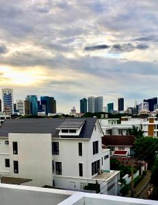 a white building with a city in the background at The Apartium - Modern Apartment Rentals in Bangkok