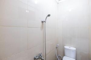 a bathroom with a shower with a toilet at SUPER OYO 2703 Hotel Transit 1 in Makassar