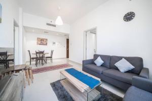 a living room with a couch and a table at StoneTree - Cozy Fully-Furnished 1 BR in Dubai