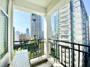 a balcony with a bench and views of a city at WH Bassac Residence in Phnom Penh