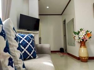 a living room with a couch and a vase of flowers at D'Mariners Inn Hotel in Batangas City