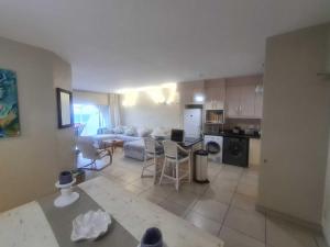 a kitchen and living room with a couch and a table at Santorini Beach Views - 23 Perissa in Ballito
