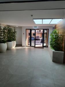 an empty lobby with potted plants in a building at Premium Hils Brauner Studio in Bucharest