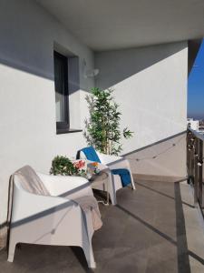 a balcony with chairs and a table on a building at Premium Hils Brauner Studio in Bucharest