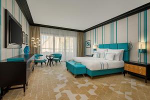 a hotel room with a bed and a television at Dinamo Hotel Baku in Baku